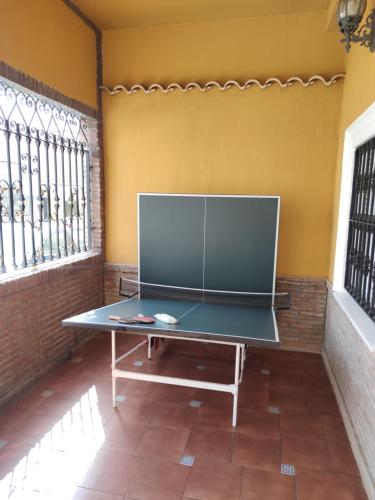 a ping pong table in the corner of a room at Villa Granada Motril in Motril