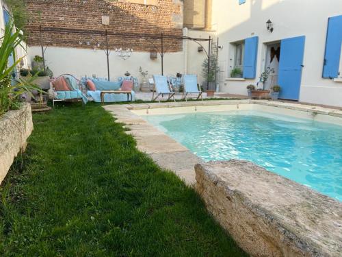 a swimming pool in the yard of a house at Maison 1823 - Suites de charme à Garons in Garons