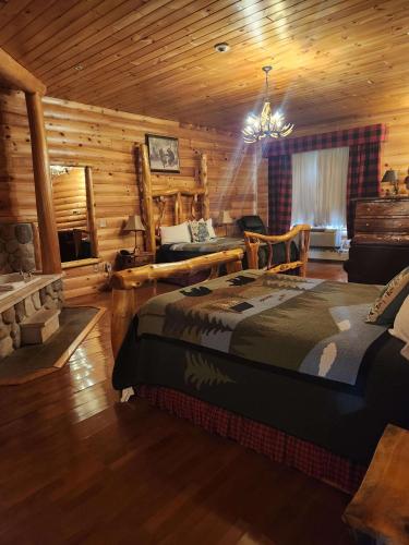 a bedroom with a bed in a log cabin at Best Western White House Inn in Bangor