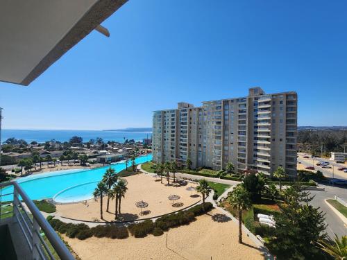 a view of the pool from the balcony of a apartment at Departamento Laguna Vista Marina in Algarrobo