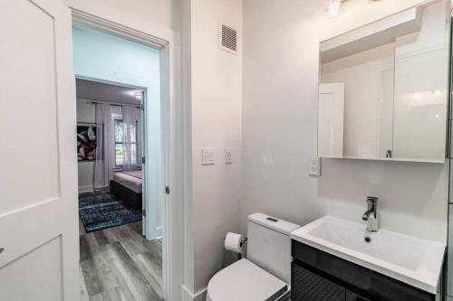 a white bathroom with a sink and a mirror at Lake apt 5 minutes to downtown, pet friendly in St Petersburg