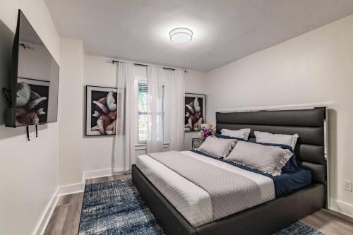 a bedroom with a large bed and a window at Lake apt 5 minutes to downtown, pet friendly in St. Petersburg