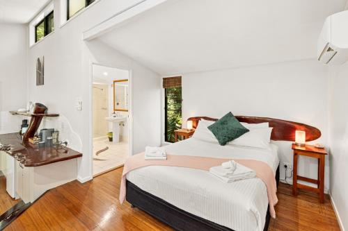 a bedroom with a large bed and a bathroom at Hunchy Hideaway in Montville