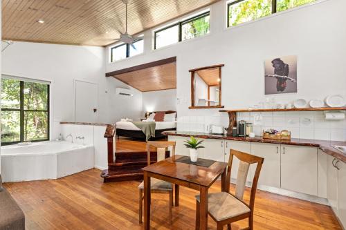 a kitchen and living room with a tub and a table at Hunchy Hideaway in Montville
