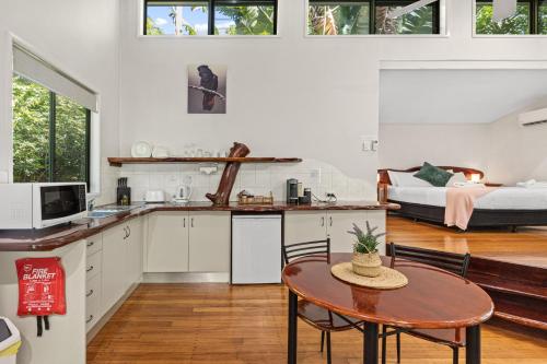 a kitchen and living room with a table and a couch at Hunchy Hideaway in Montville
