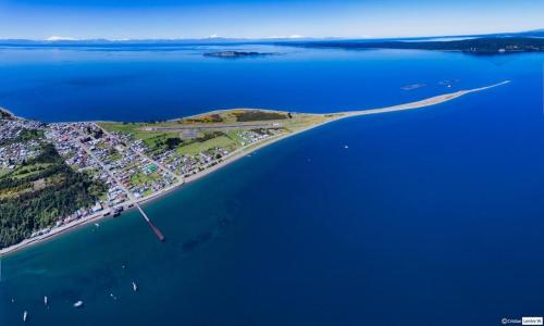 an aerial view of an island in the water at Cabañas Bosquemar 1 in Queilén