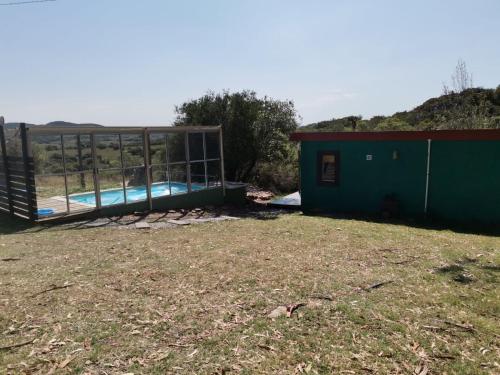 a house with a swimming pool in a yard at Casa CALMA en Villa Serrana in Villa Serrana