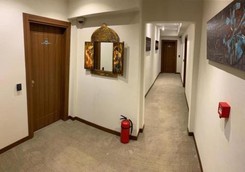 a hallway with a red fire hydrant in a building at Royal Butik House in Bursa