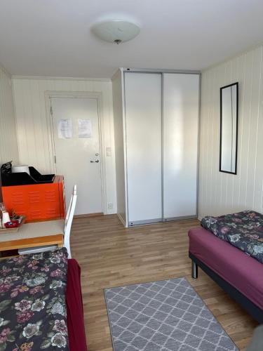 a room with a bed and a desk and a bed sidx sidx sidx at Bedroom in city centre, no shower available in Ålesund
