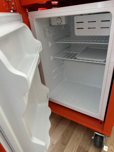 an empty refrigerator with its door open with its door open at Bedroom in city centre, no shower available in Ålesund