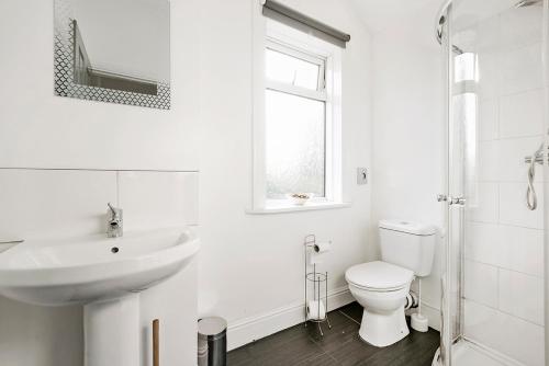 a white bathroom with a sink and a toilet at Group Stays Birmingham in Birmingham