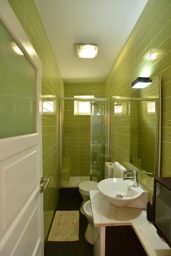 a bathroom with a sink and a toilet and a shower at Casa da Fonte in Sintra