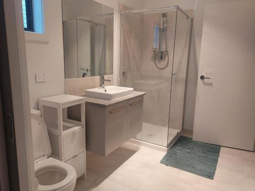 a bathroom with a shower and a sink and a toilet at bamboo in Apollo Bay