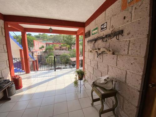 a room with a brick wall and a table and a balcony at Hotel Mirador Real in Bernal