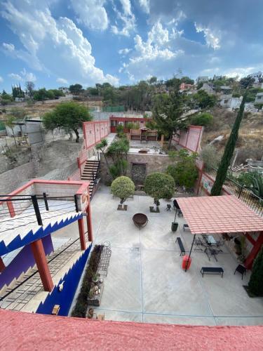 a view of a patio with tables and benches at Hotel Mirador Real in Bernal