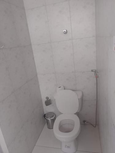 a bathroom with a white toilet in a stall at Pousada Pôr do Sol in Barra Grande