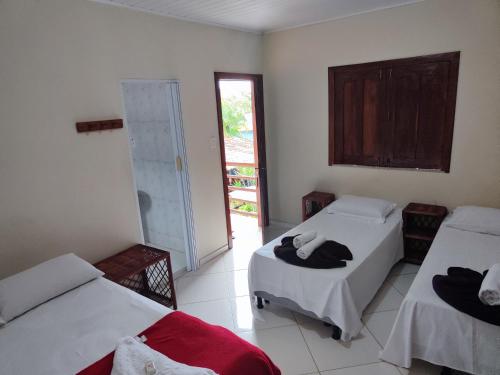 a room with two beds and a window at Pousada Pôr do Sol in Barra Grande