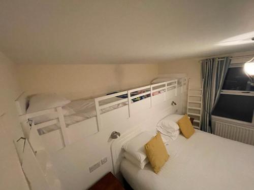 a bedroom with two bunk beds and a white bed at The Portaferry Hotel in Portaferry