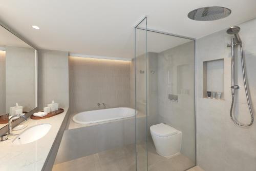 a bathroom with a shower and a toilet and a sink at JW Marriott Gold Coast Resort & Spa in Gold Coast