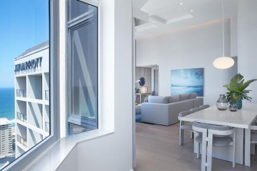 a dining room and living room with a large window at JW Marriott Gold Coast Resort & Spa in Gold Coast