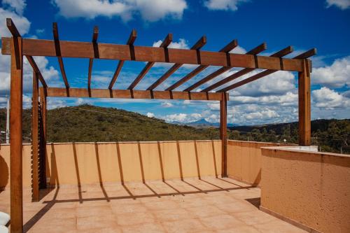 a wooden pergola sitting on top of a roof at SO HAM Guest House in Diamantina