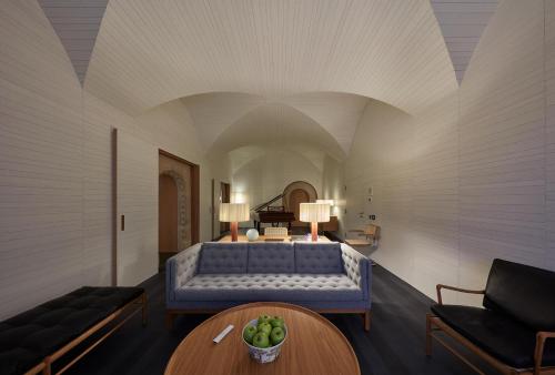 a living room with a bed and a table at Casa Palacio PAREDES SAAVEDRA by ATRIO in Cáceres