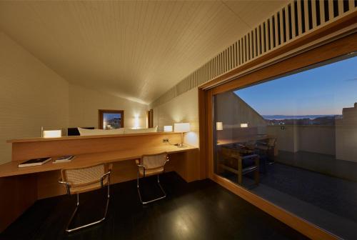 a room with a desk and a large window at Casa Palacio PAREDES SAAVEDRA by ATRIO in Cáceres