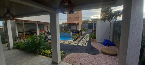 a patio with a swimming pool and a house at Mangabeiras - Casa de Hóspedes in Alto Paraíso de Goiás