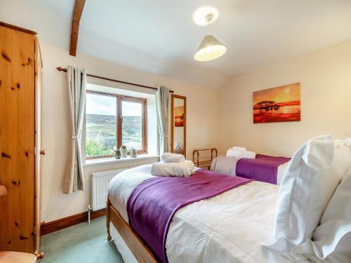 a bedroom with two beds and a window at The Haybarn - Uk42935 in Rosedale Abbey