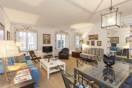 a living room with a blue couch and a table at Bairrus Lisbon Apartments - Alfama II in Lisbon