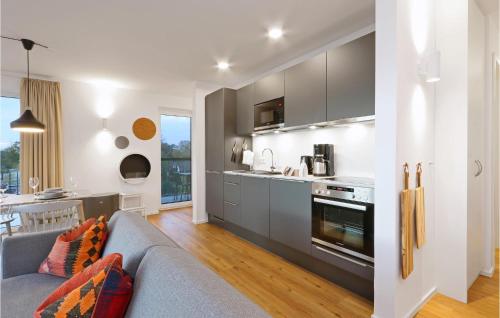 a living room with a couch and a kitchen at Cozy Apartment In Lembruchdümmer See in Lembruch