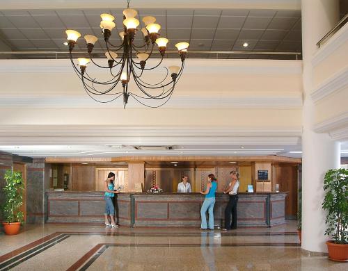 a group of people standing in the lobby of a hotel at Nissiana Hotel & Bungalows in Ayia Napa