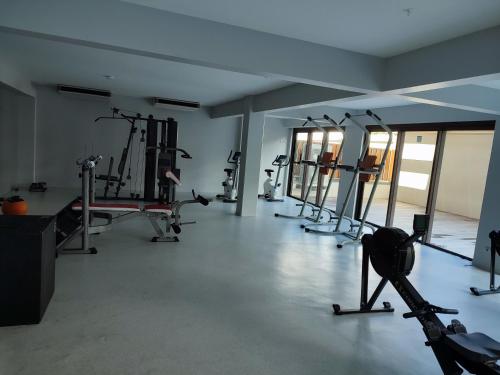 a gym with several tread machines in a room at Studio Blue Moana - Private apartment with sea view in Papeete