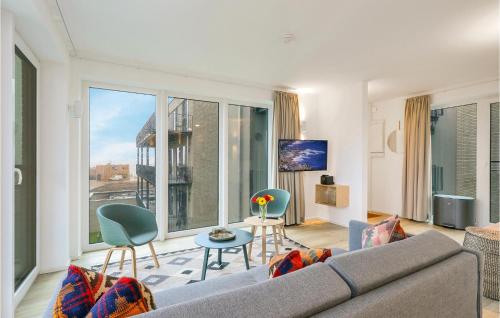 レンブルッフにあるNice Apartment In Lembruchdümmer Seeのソファと大きな窓のあるリビングルーム