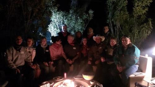 a group of people posing for a picture at night at My Place Suites in Wickenburg