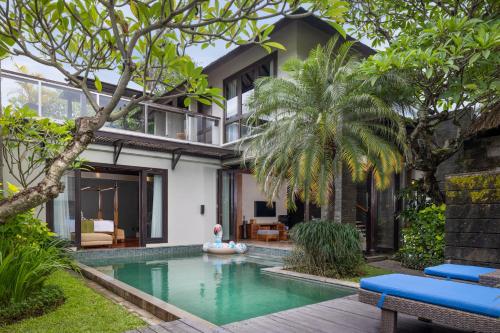 an external view of a villa with a swimming pool at Le Jardin Villas Seminyak in Seminyak
