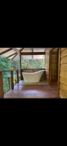 a bath tub in a room with a window at Casita Dulce in Pavones
