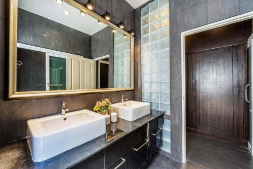 a bathroom with two sinks and a mirror at 3 Bedroom Pool Villa in Great Location STV in Hua Hin