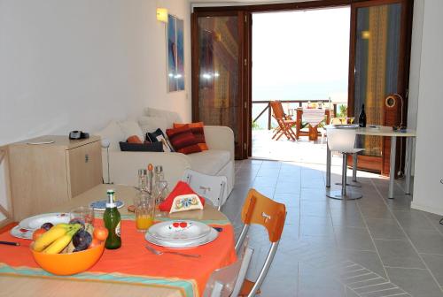 a living room with a table with fruit on it at Villa Arborea in Sperlonga in Sperlonga