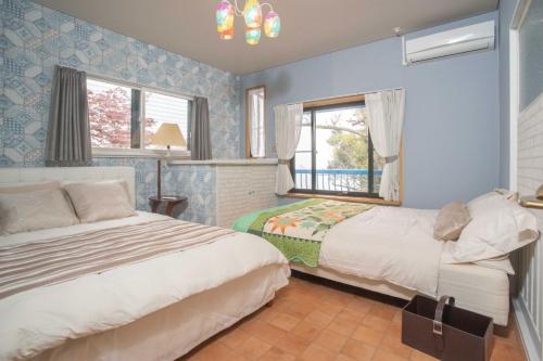 Postel nebo postele na pokoji v ubytování ゴンドラヴィラ イン熱海2階HakoneAtamiYugawara