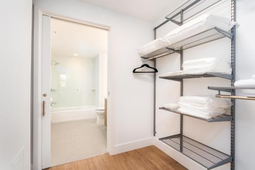 a walk in closet with shelves and a door at Locale Menlo Park in Menlo Park