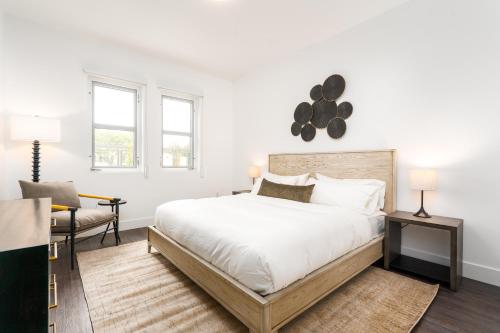 a white bedroom with a large bed and a chair at Mint House Menlo Park by Kasa in Menlo Park