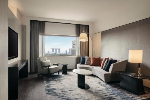 a living room with a couch and a chair at Hilton Singapore Orchard in Singapore