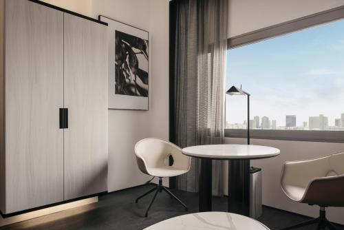 a room with a table and chairs and a window at Hilton Singapore Orchard in Singapore