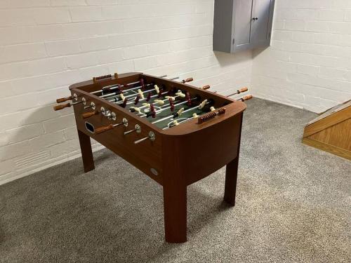 a large wooden foosball table in a room at The Parsonage of Marshall-4BR 2BA Entire House in Marshall