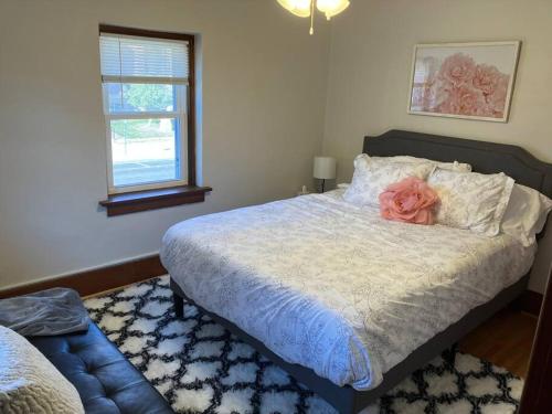 a bedroom with a bed with a pink rose on it at The Parsonage of Marshall-4BR 2BA Entire House in Marshall