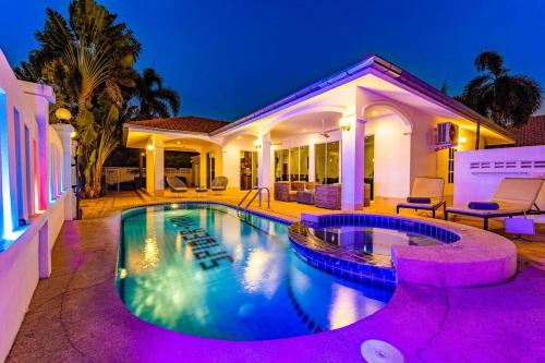 a house with a swimming pool at night at Private 4 Bedroom Pool Villa NG411 in Hua Hin
