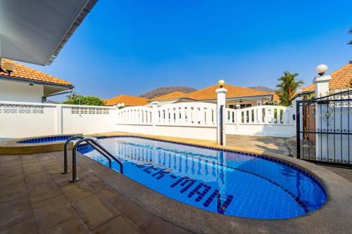 a swimming pool in the backyard of a house at Private 4 Bedroom Pool Villa NG411 in Hua Hin