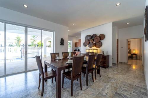 a kitchen and dining room with a table and chairs at Private 4 Bedroom Pool Villa NG411 in Hua Hin