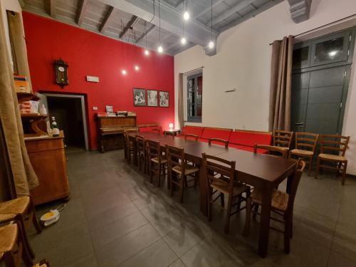 a dining room with a long table and chairs at B&B e Ostello, Parco di Monza, CASCINA COSTA ALTA in Monza